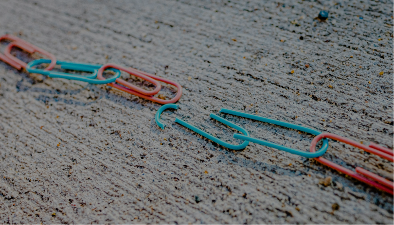 A chain of interlinked paperclips, representing the legal and emotional connections in a spouse visa relationship and what happens when those links are broken.