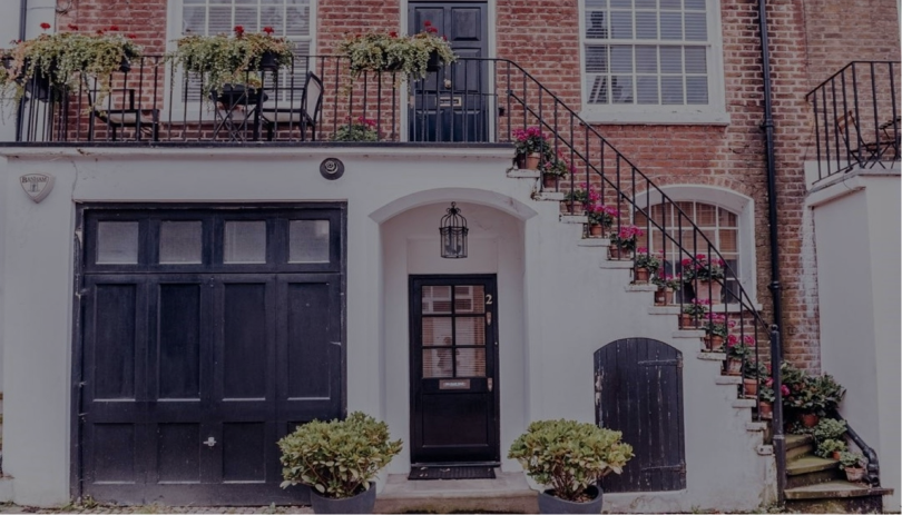 A welcoming home with a staircase and flowers, illustrating the idea of stability and security in a spouse visa relationship, which may be threatened if the visa is cancelled.