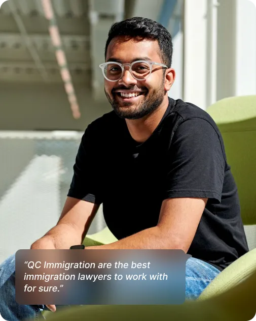 A man in glasses seated on a chair, with text stating "QC Immigration is the best partner for visa application support."